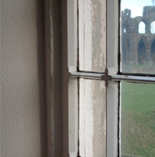 detail of 19th century “quatrefoil” glazing bars - the ruins of Whitby Abbey in the distance