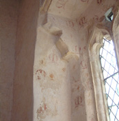 Chapel window at Bradwell Abbey, ca. 1340. The contemporary, stylised painted letter ‘M’ refers to the Virgin Mary, to whom the chapel was dedicated